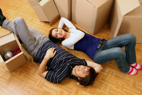 Moving team handling furniture near Spitalfields buildings
